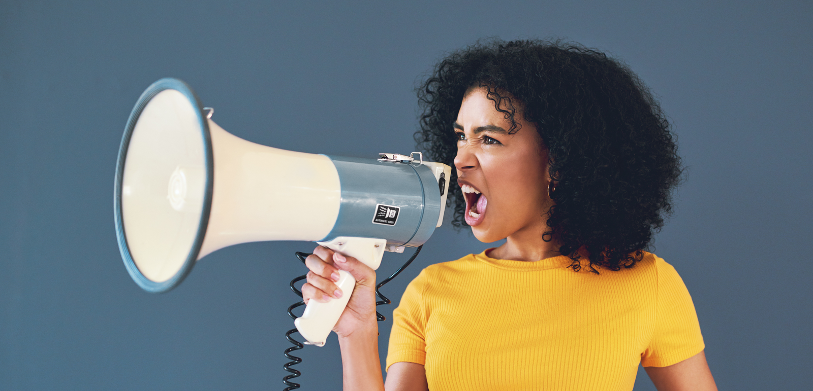 Woman showing the power of her voice by speaking into a megaphone