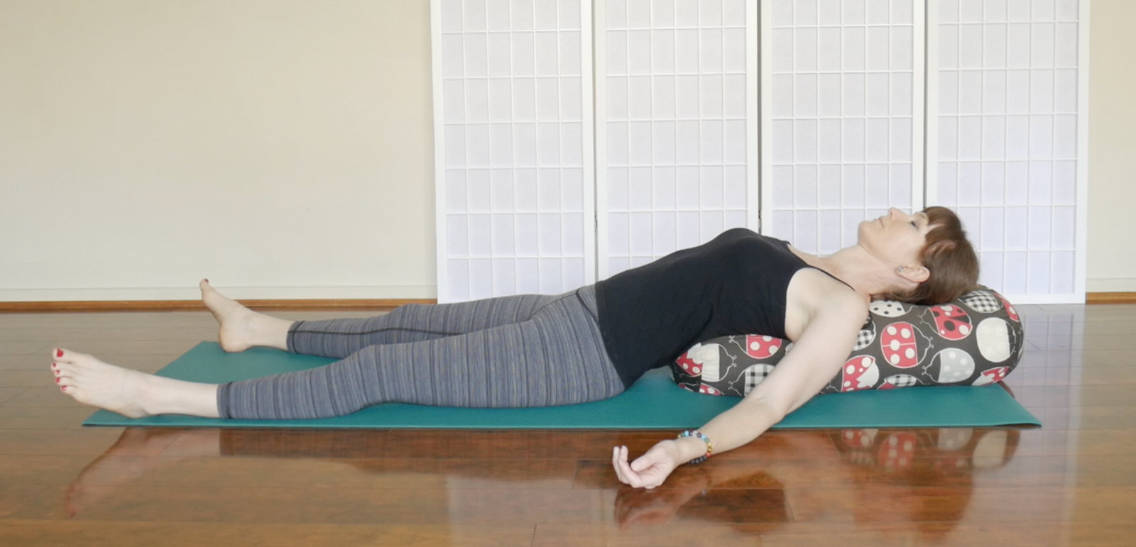 woman demonstrating restorative yoga version of fish pose